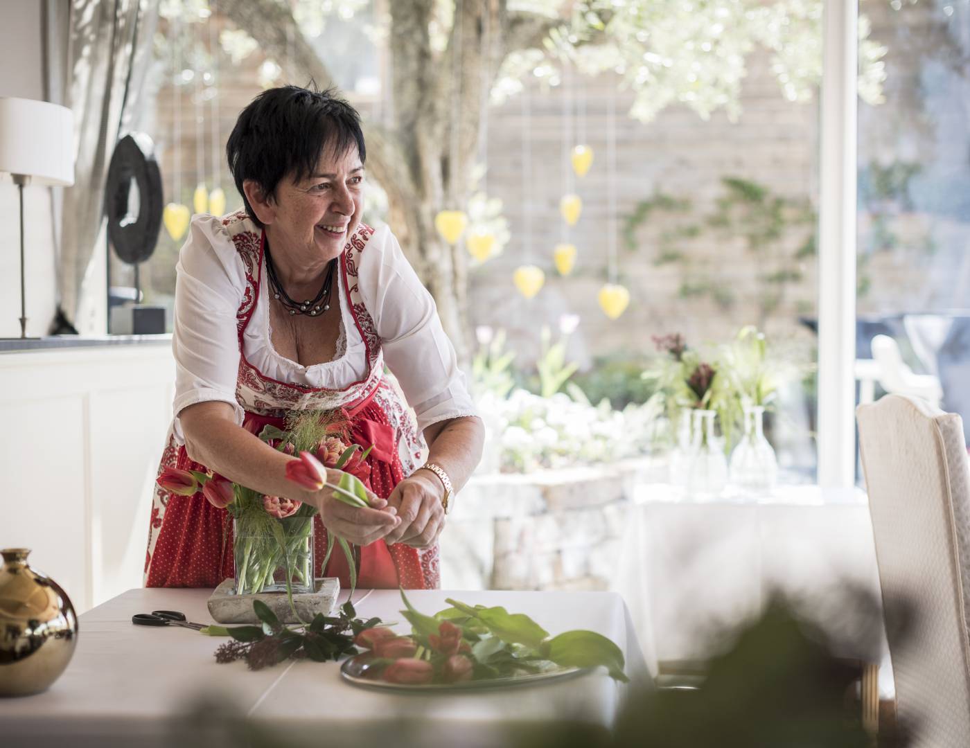 Hostess Erika Nestl decorating a table at Hotel Erika in Dorf Tirol