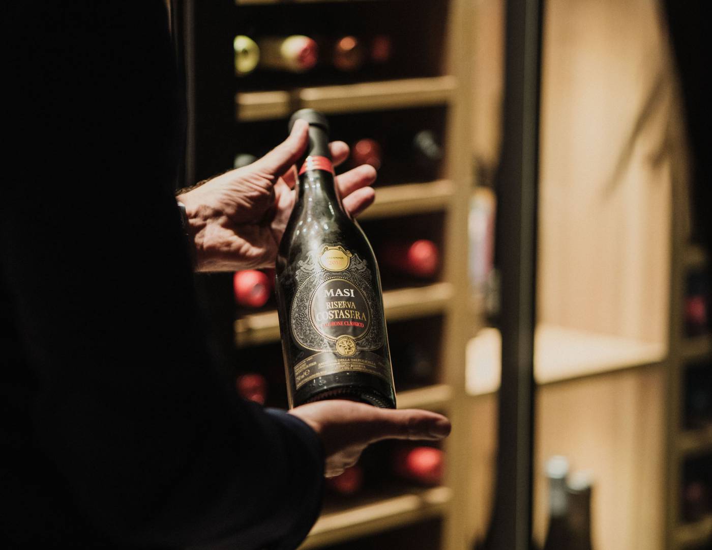 Sommelier Andreas in front of the wine cabinet at Hotel Erika