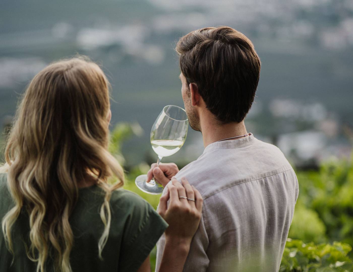 Couple enjoying wine and the view of Merano