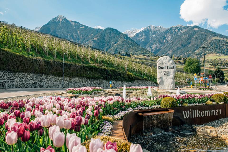 Entrance to the holiday village of Dorf Tirol with a view of the village
