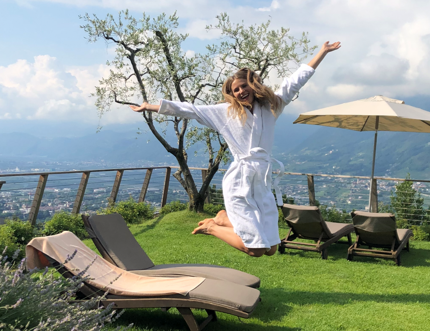 Frau in Bademantel springt auf der Terrasse